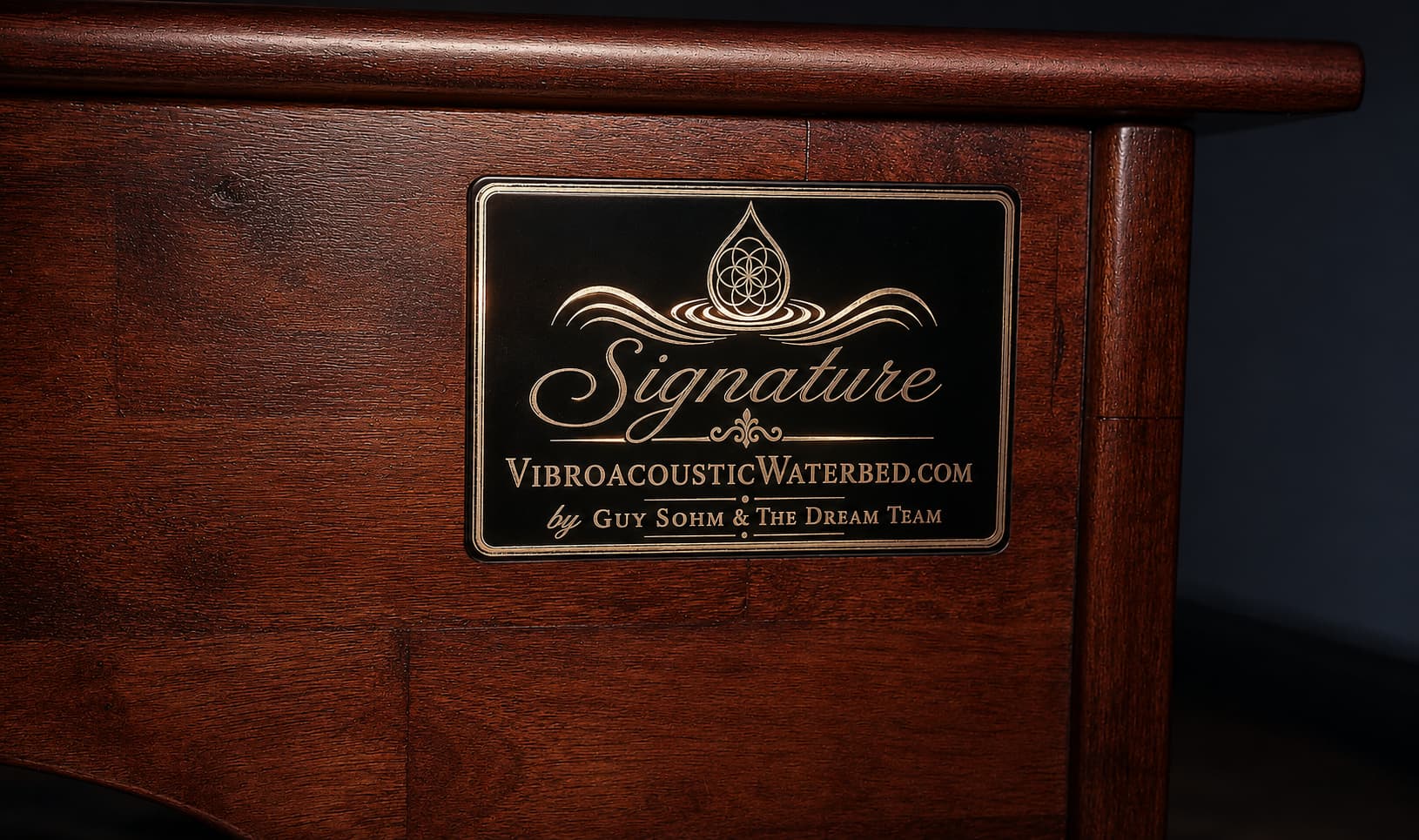 **Alt Text:** Luxury handcrafted signature vibroacoustic waterbed system with premium timber finish and custom engraved plaque by Guy Sohm & The Dream Team